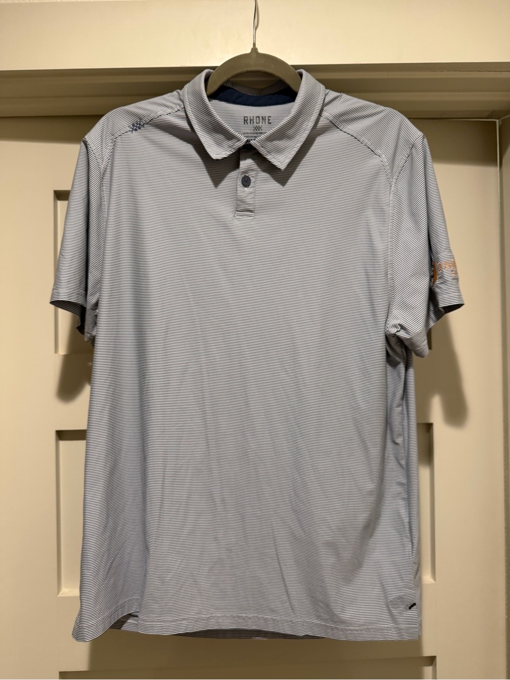 Rhône Men’s Performance Golf Polo Navy White Stripe with a company Logo L